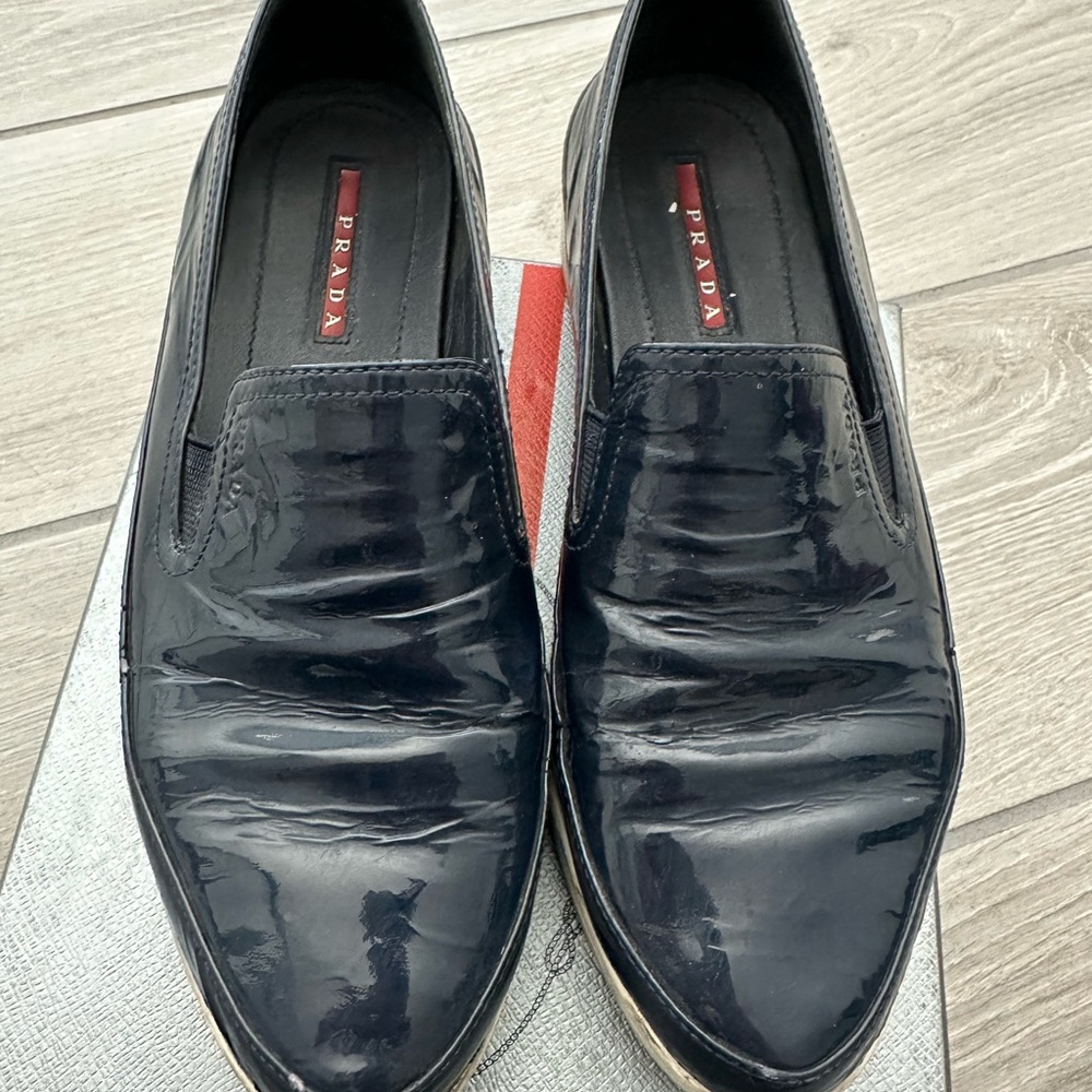 Prada Women’s patent Navy Slip-On sneaker